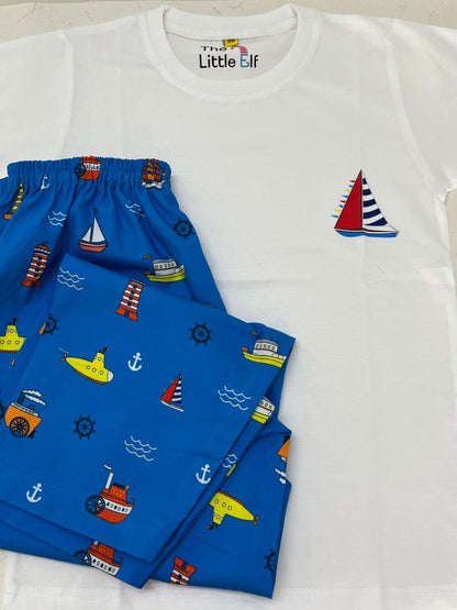 White t-shirt with red and blue designs and blue shorts with colorful patterns on a white surface.